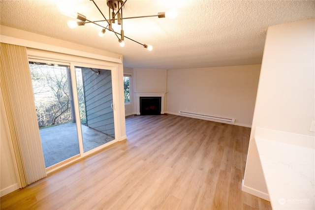 unfurnished living room with a baseboard radiator, a textured ceiling, and light hardwood / wood-style floors