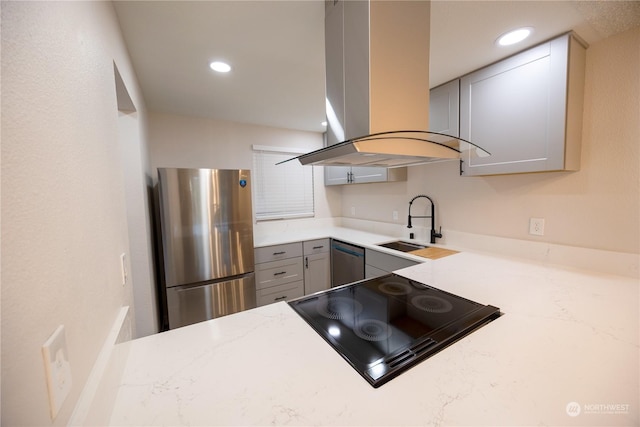 kitchen featuring sink, gray cabinetry, island exhaust hood, stainless steel appliances, and light stone countertops