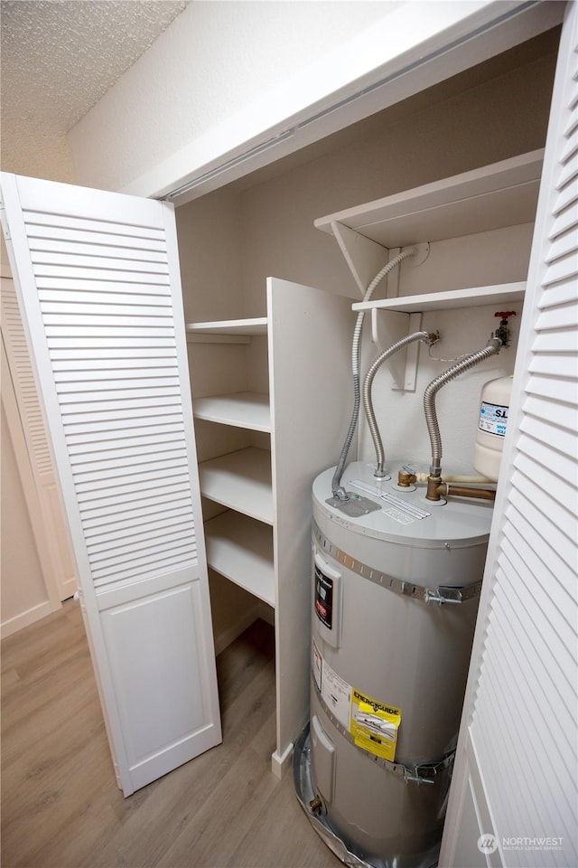 utility room featuring strapped water heater