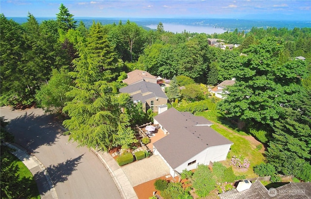 drone / aerial view featuring a water view and a view of trees