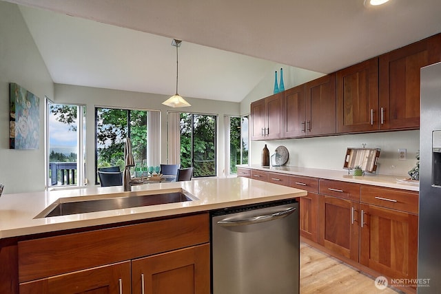 kitchen featuring light countertops, appliances with stainless steel finishes, and a sink