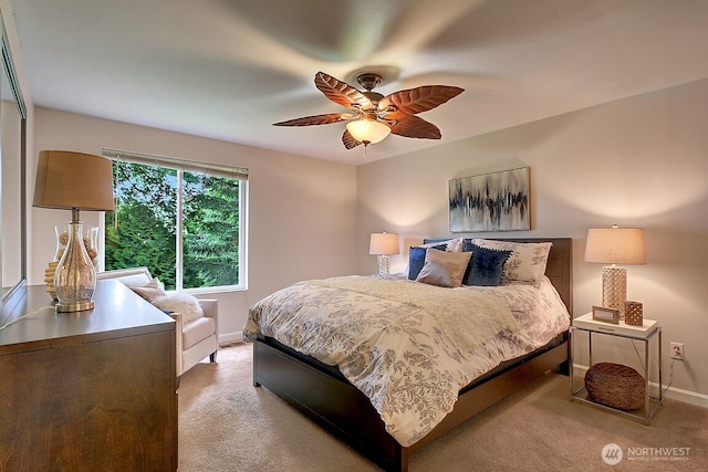 bedroom featuring light colored carpet, ceiling fan, and baseboards