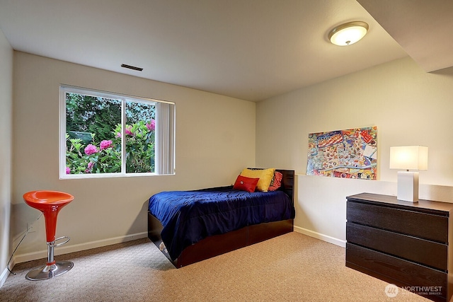 bedroom featuring carpet and baseboards