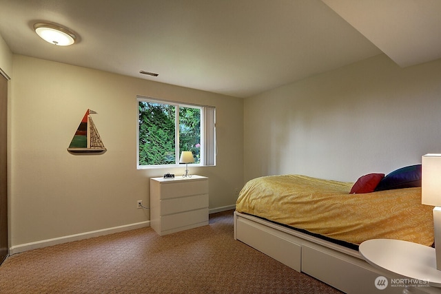 bedroom featuring baseboards and visible vents