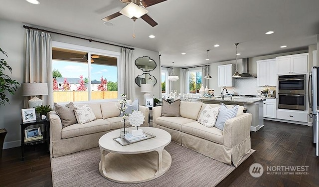 living room featuring ceiling fan and dark hardwood / wood-style flooring