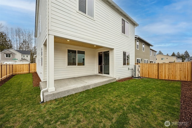 rear view of house with a yard and a patio