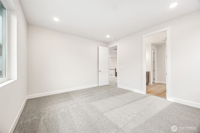 unfurnished bedroom featuring light colored carpet