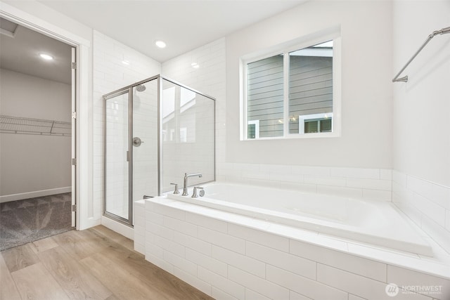 bathroom with wood-type flooring and plus walk in shower