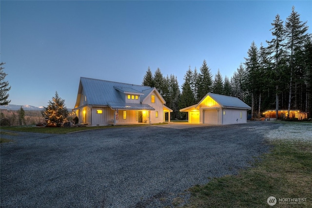 view of front of home with a garage, an outdoor structure, and a yard