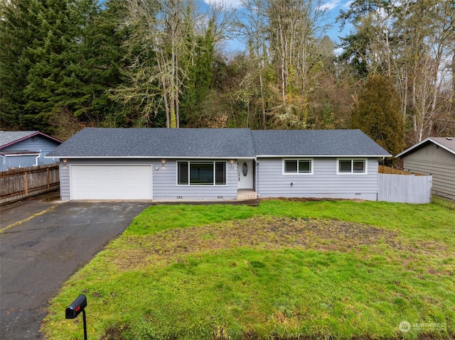 ranch-style home with a garage and a front lawn