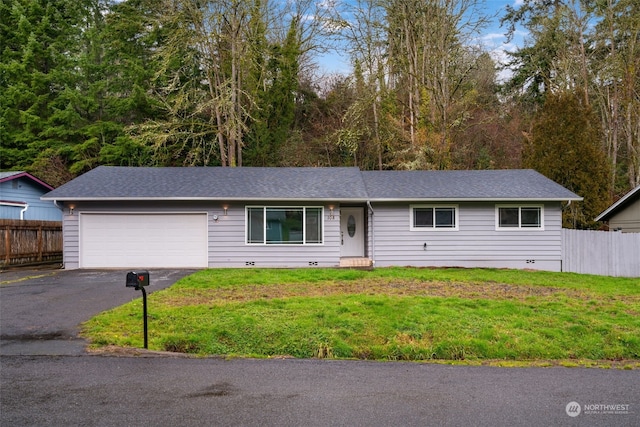 single story home featuring a garage and a front yard