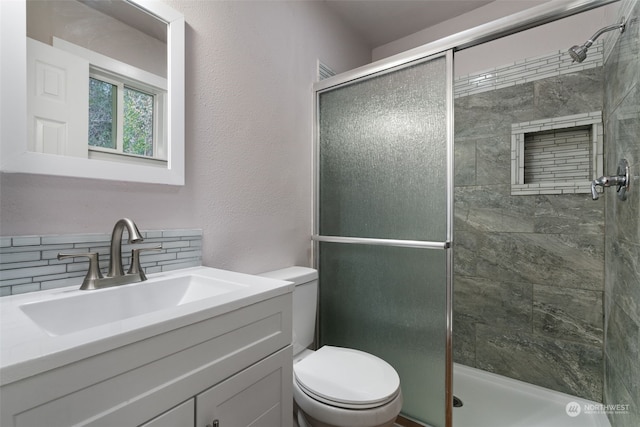 bathroom featuring walk in shower, vanity, and toilet