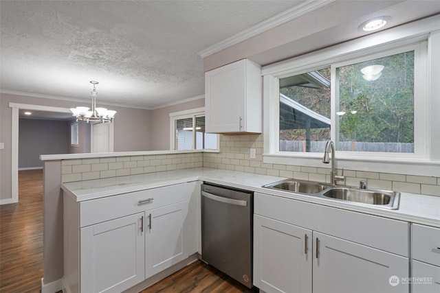 kitchen featuring sink, stainless steel dishwasher, ornamental molding, pendant lighting, and white cabinets