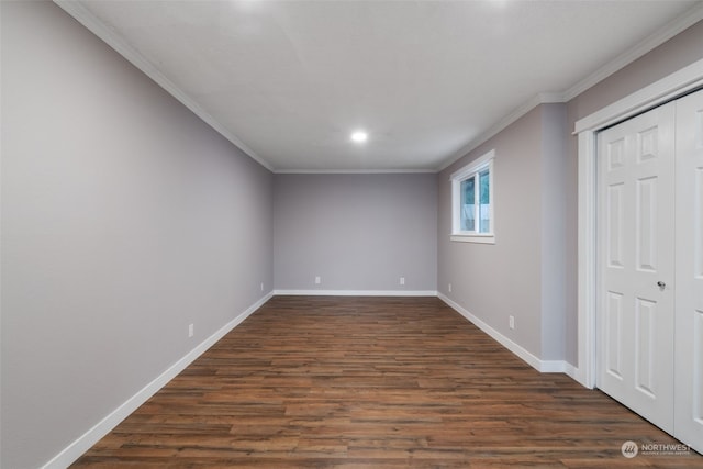 spare room featuring crown molding and dark hardwood / wood-style flooring