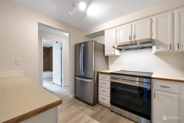 kitchen featuring appliances with stainless steel finishes, white cabinets, and light hardwood / wood-style floors