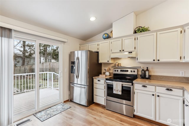 kitchen featuring stainless steel appliances, vaulted ceiling, white cabinets, and light wood-type flooring