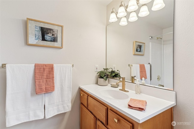 bathroom with vanity and a shower