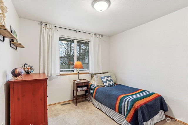 bedroom featuring light colored carpet