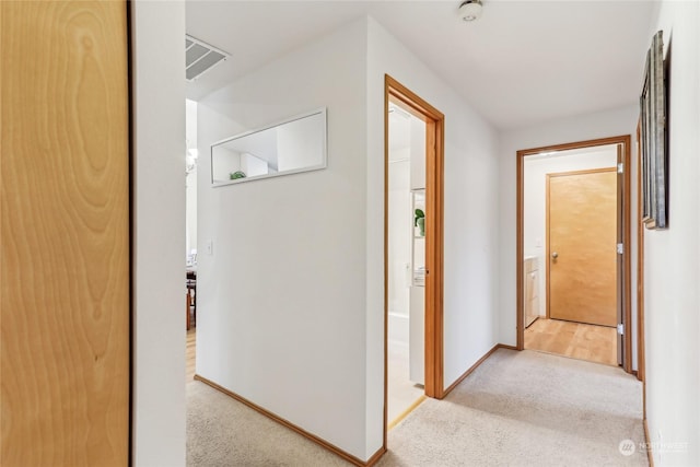 corridor with light colored carpet