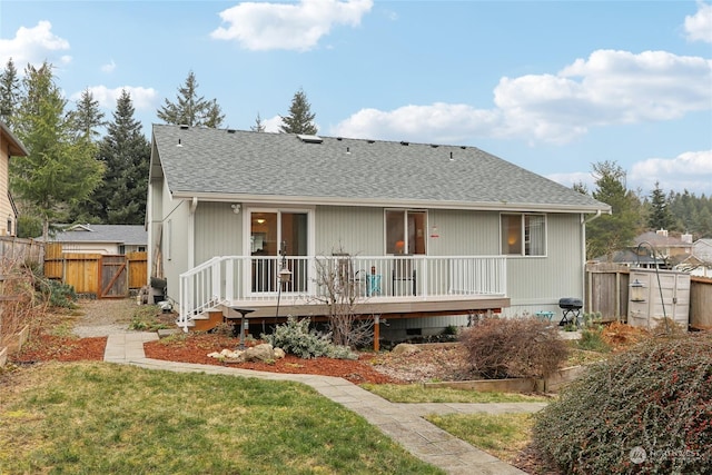 back of property featuring a yard and a deck