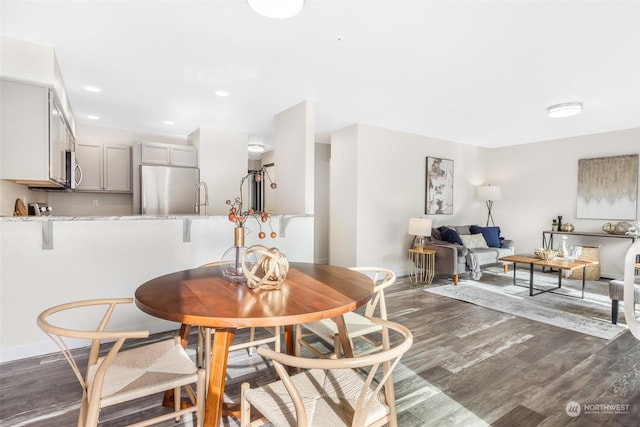 dining space featuring dark wood-type flooring