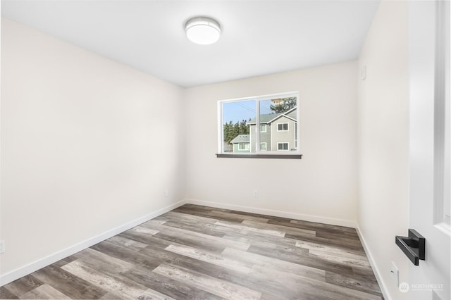 spare room featuring hardwood / wood-style flooring