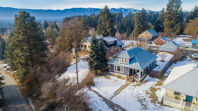 snowy aerial view with a mountain view