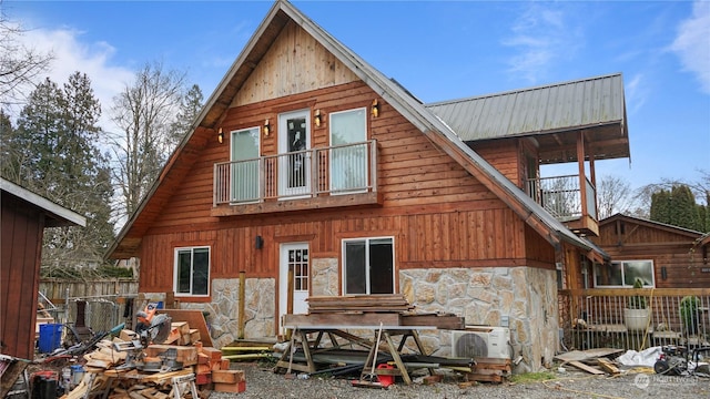 rear view of house with a balcony and ac unit