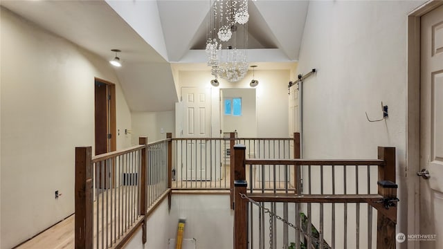 corridor featuring a barn door and light hardwood / wood-style flooring