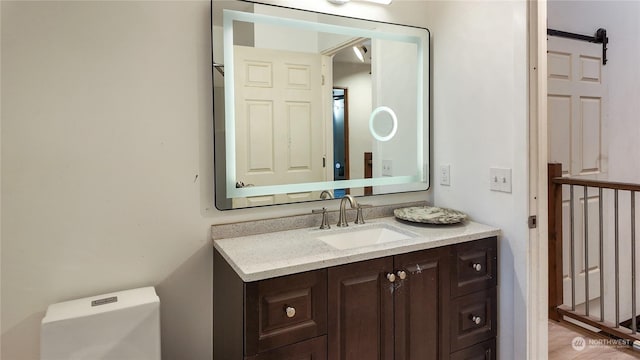 bathroom with vanity and toilet