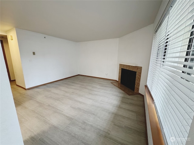 unfurnished living room with a premium fireplace and light wood-type flooring