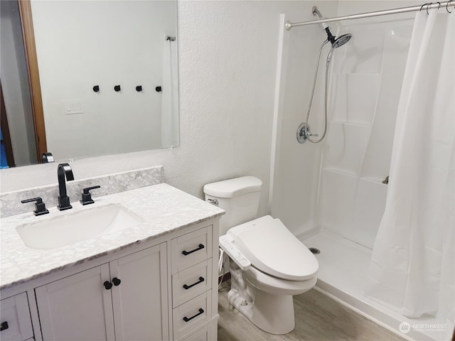 bathroom with hardwood / wood-style flooring, vanity, toilet, and a shower with curtain