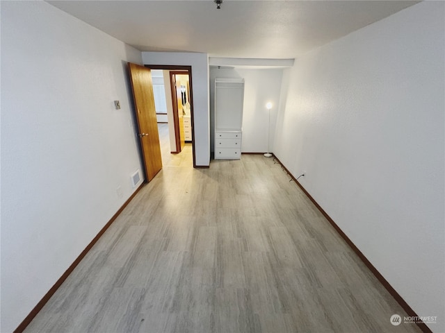 unfurnished room with light wood-type flooring