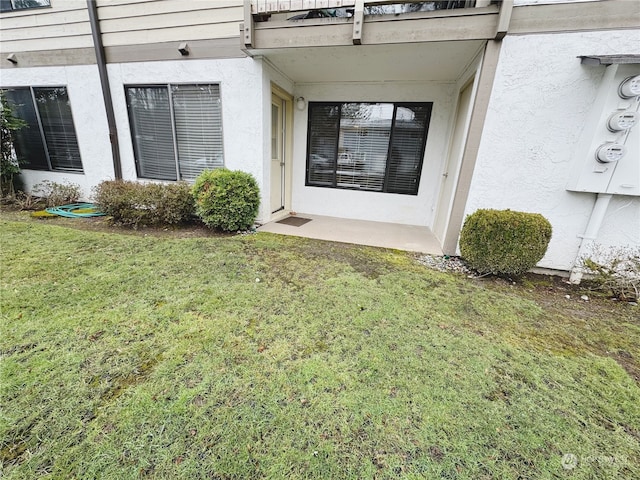 entrance to property with a lawn