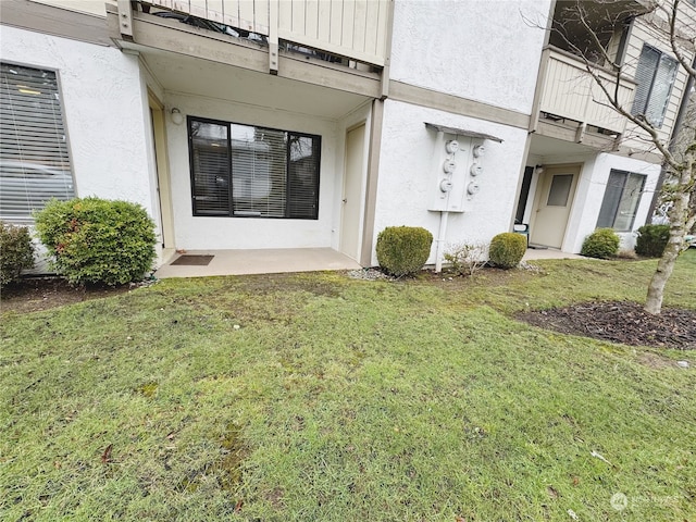 property entrance with a lawn