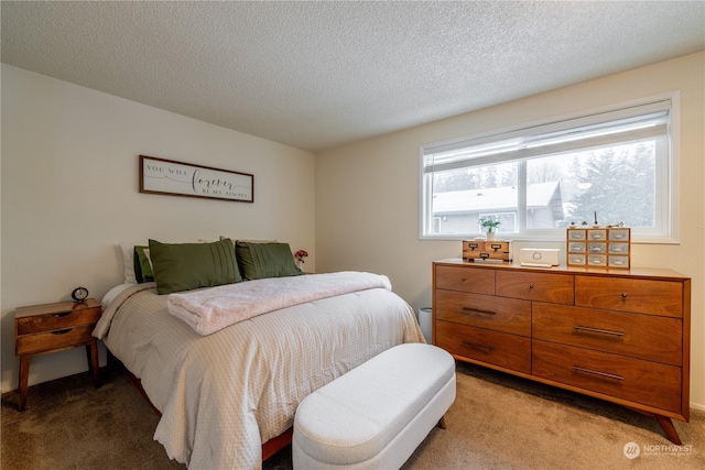 bedroom featuring a textured ceiling and light colored carpet