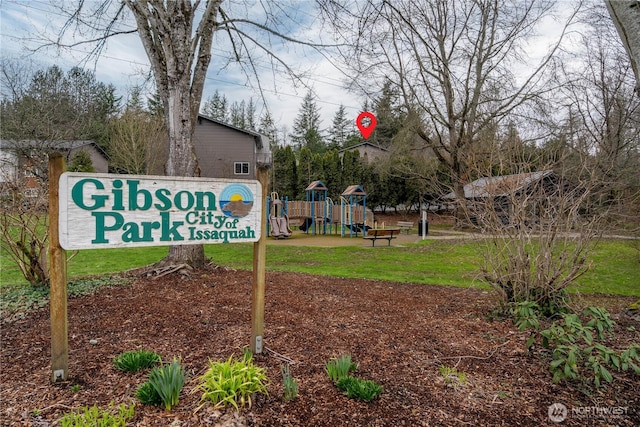 view of home's community featuring playground community and a lawn