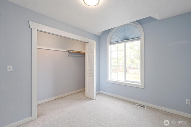 unfurnished bedroom with carpet floors, visible vents, and baseboards