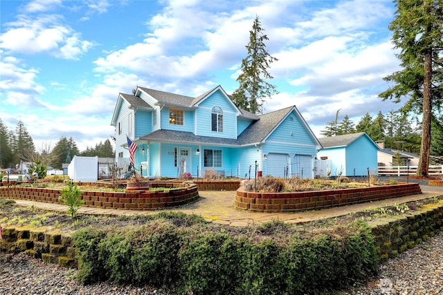 view of front of house with a garage and fence