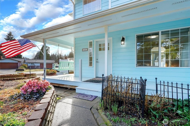 view of exterior entry featuring a porch