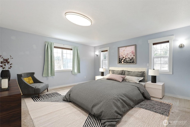 bedroom featuring carpet and baseboards