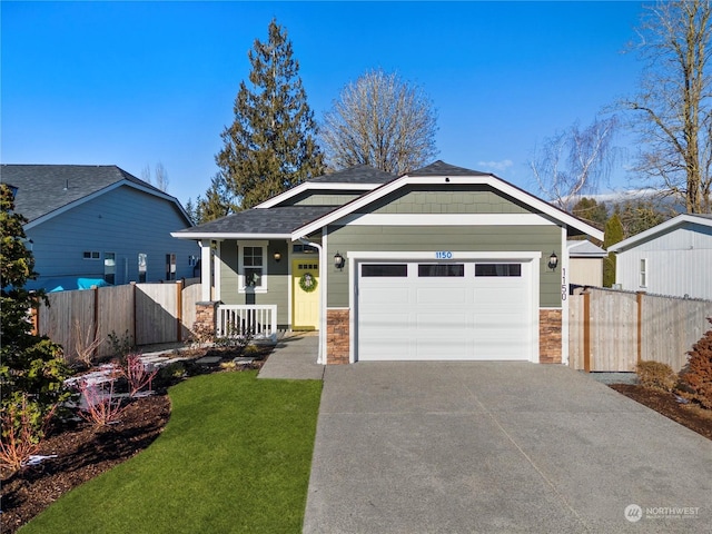 view of front of home featuring a garage and a front yard