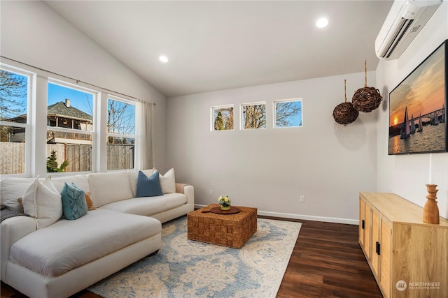 living room featuring dark hardwood / wood-style floors, vaulted ceiling, and a wall unit AC