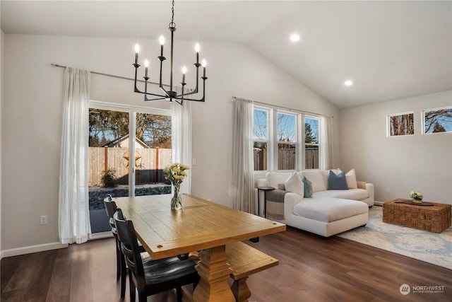 dining space with an inviting chandelier, high vaulted ceiling, and dark hardwood / wood-style floors