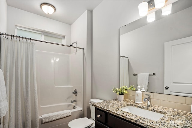 full bathroom with vanity, shower / bath combination with curtain, and toilet