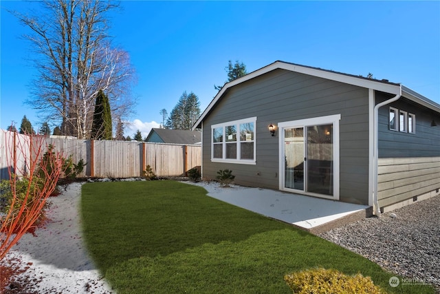 rear view of property with a yard and a patio area