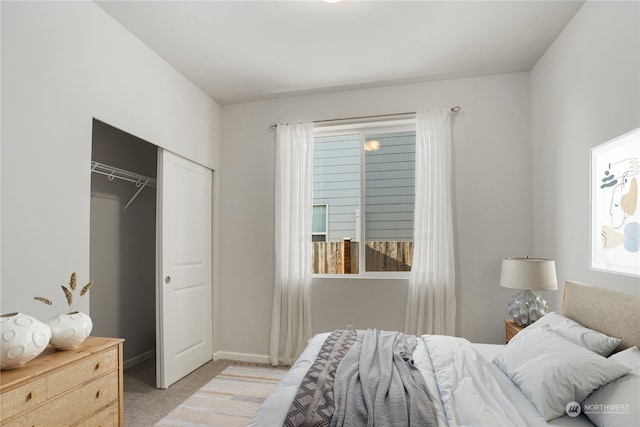 carpeted bedroom featuring multiple windows and a closet