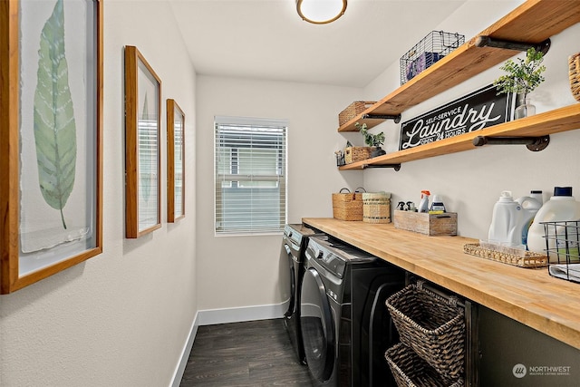 clothes washing area with dark hardwood / wood-style floors and washer and clothes dryer