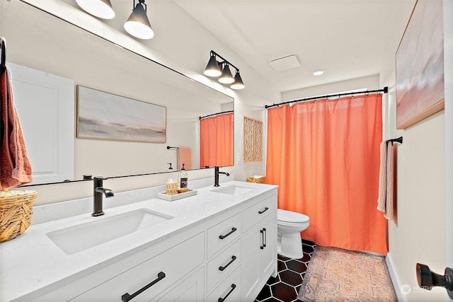 bathroom featuring vanity and toilet