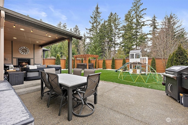 view of patio featuring an outdoor living space with a fireplace and a playground